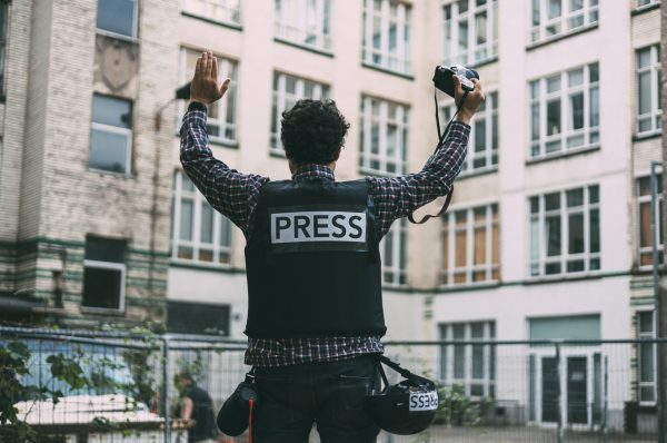 photojournalist-in-bulletproof-vest-holding-his-ca-2025-01-10-05-33-27-utc